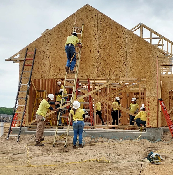 Volunteers building a house at Habitat for Humanity