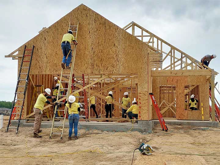 Volunteers building a house at Habitat for Humanity