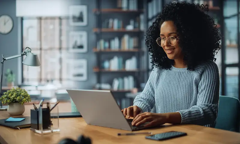 Lady sitting at laptop in home office