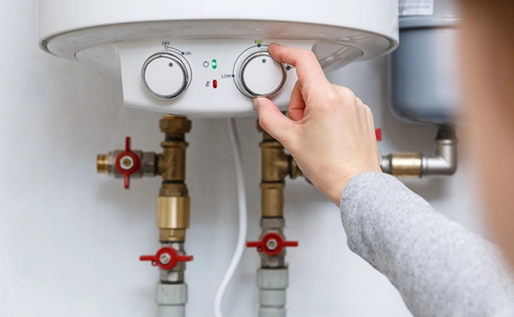 Homeowner adjusting water heater