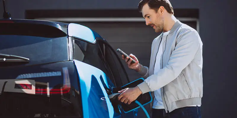 Man charging his EV at home