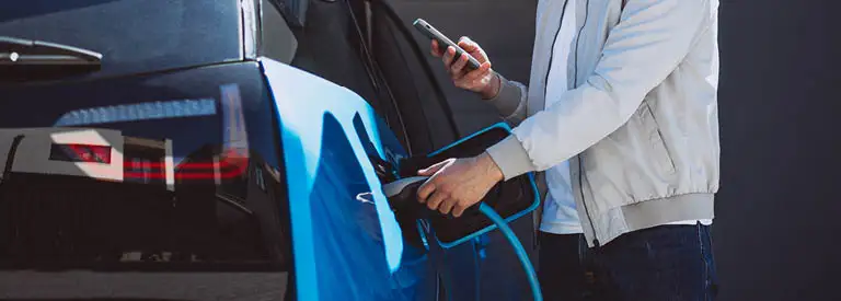 Man charging his EV at home