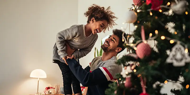 Daughter and dad near the Christmas tree
