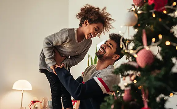 Daughter and dad near the Christmas tree