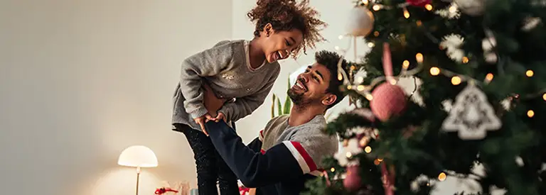 Daughter and dad near the Christmas tree