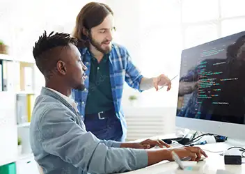 Business meeting with employees around a laptop