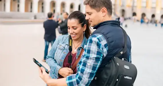 Tourist couple looking at phone together