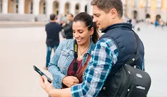 Tourist couple looking at phone together