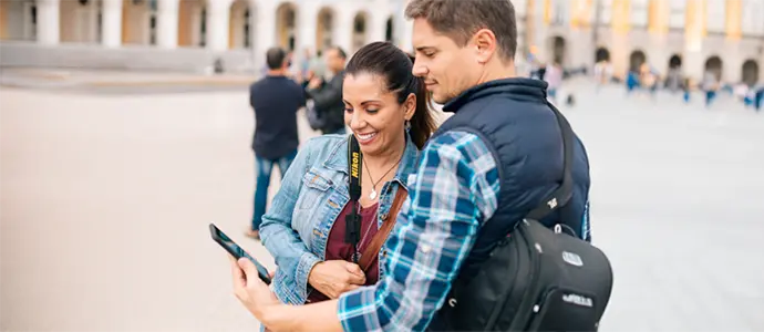 Tourist couple looking at phone together