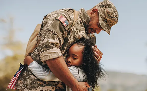 Affectionate military reunion between father and daughter