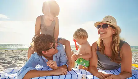 Family playing at the beach and having fun