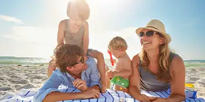 Family playing at the beach and having fun