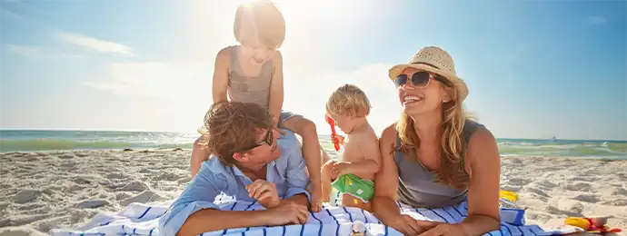 Family playing at the beach and having fun