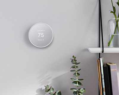 nest thermostat with 75 degrees on a gray wall