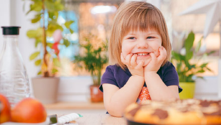 Young toddler sitting at kitchen table